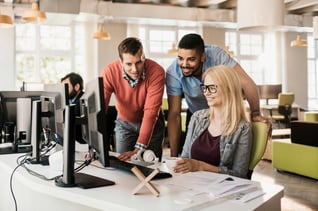 coworkers-looking-at-computer-screen