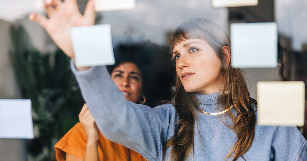 women with post-it notes prioritizing prospects